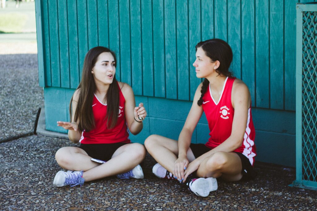 Women in red top sitting on the floor