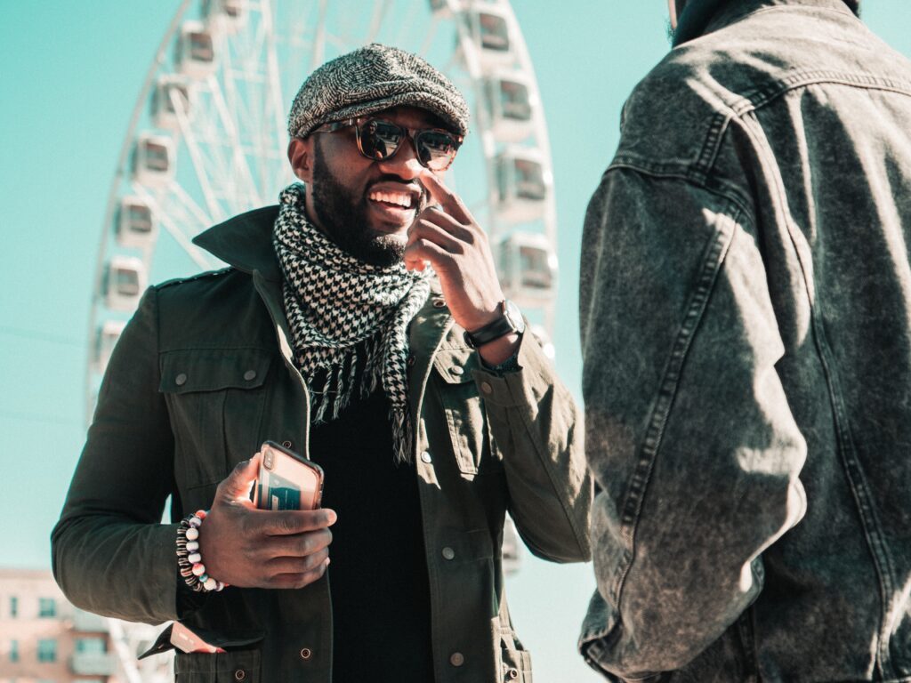 Man in black coat holding a mug