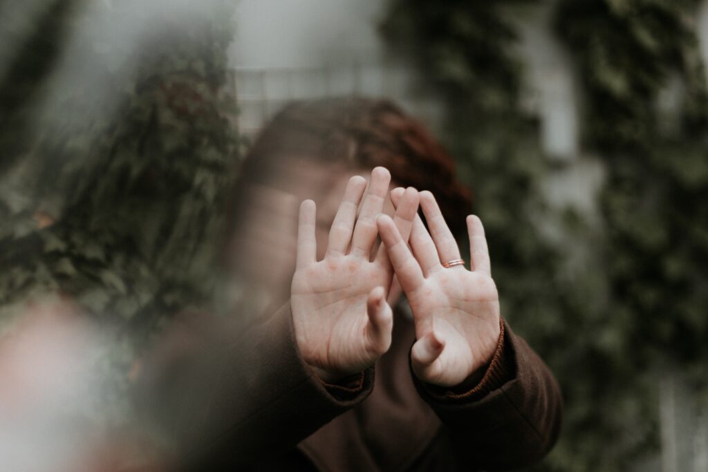 Person covering face with hand