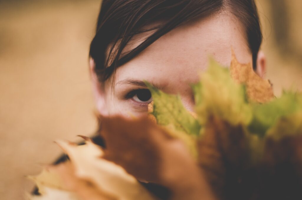 Girl behind leaves