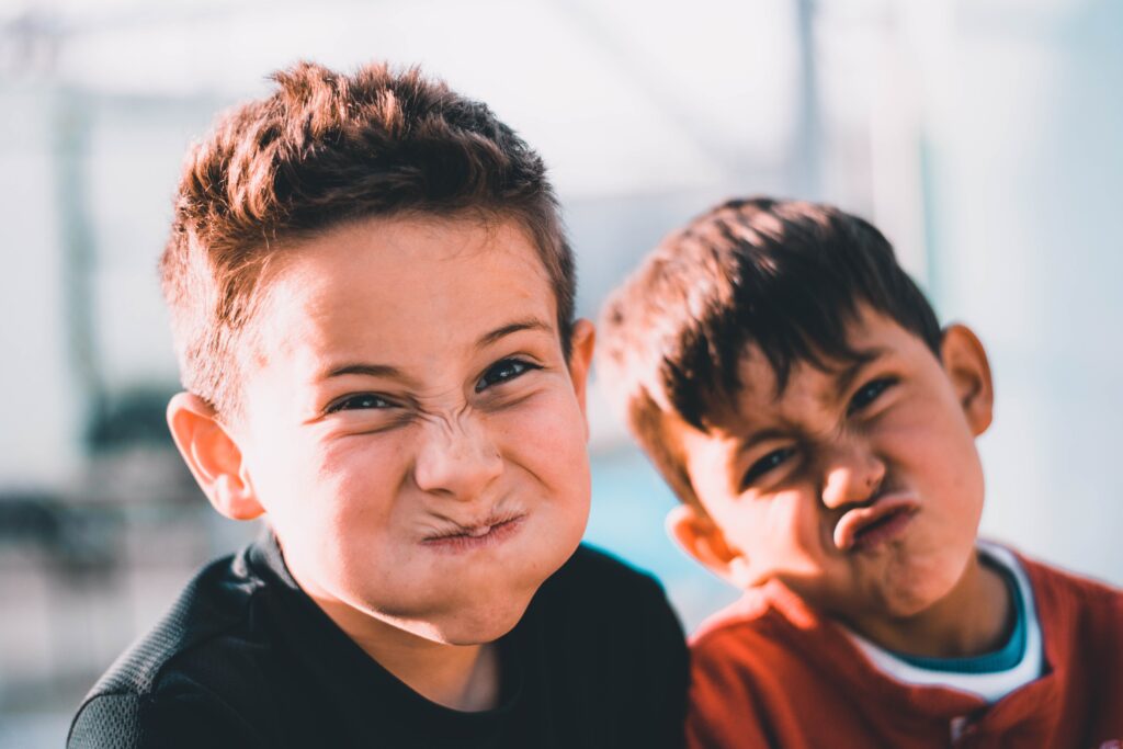 Two kids making wacky faces