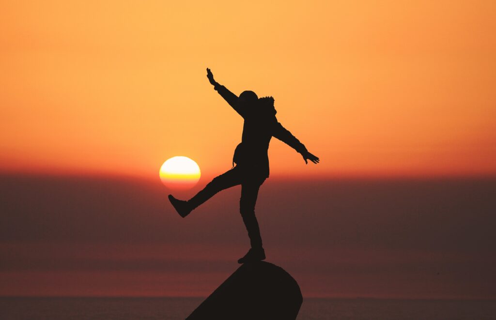 Silhouette of man on a rock