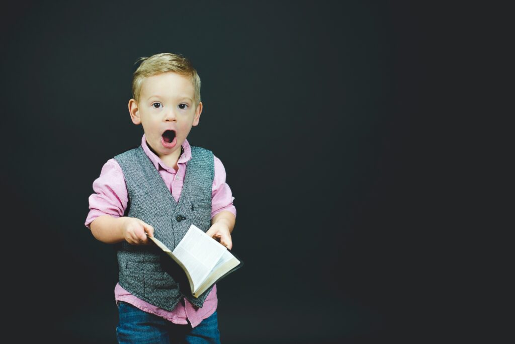 Boy holding a book and talking