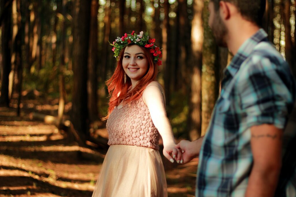 Girl with floral headband in the woods with man