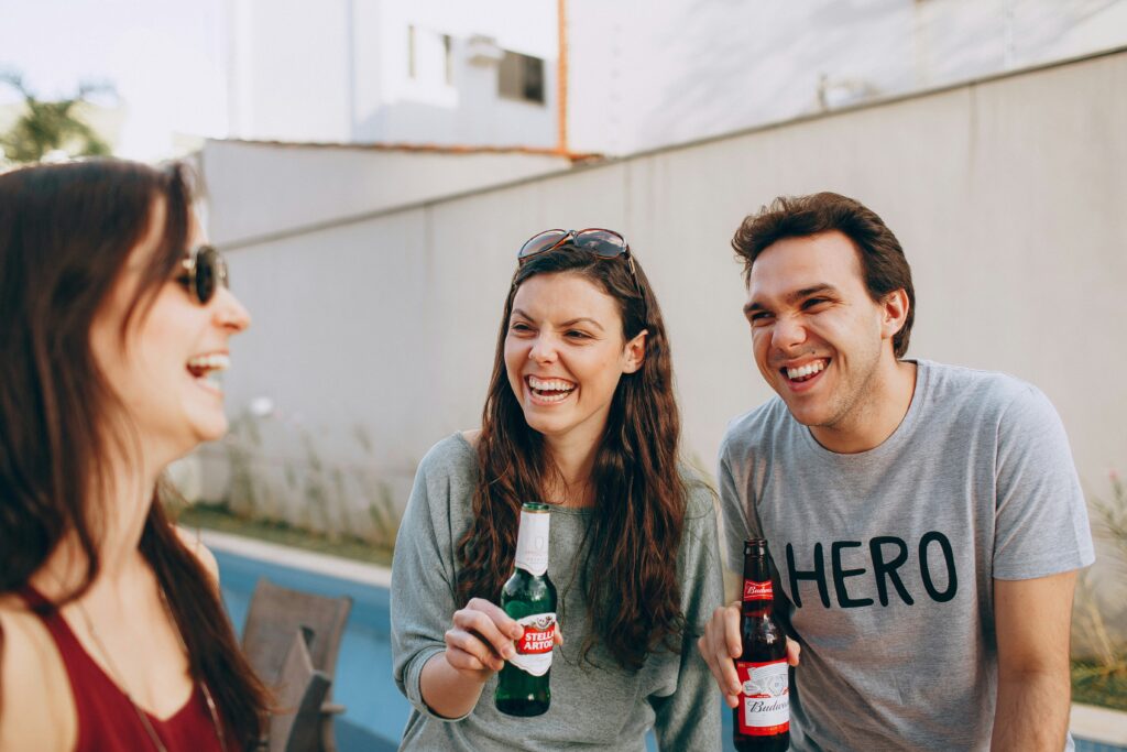 Group with bottles of drinks laughing