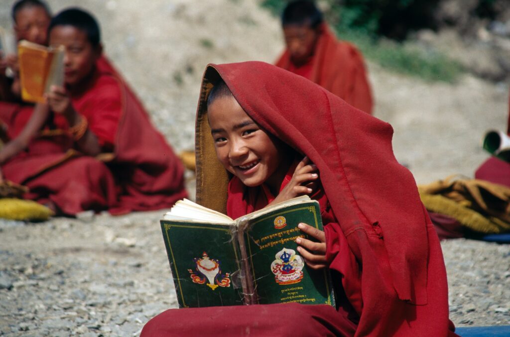 Shy boy holding a book