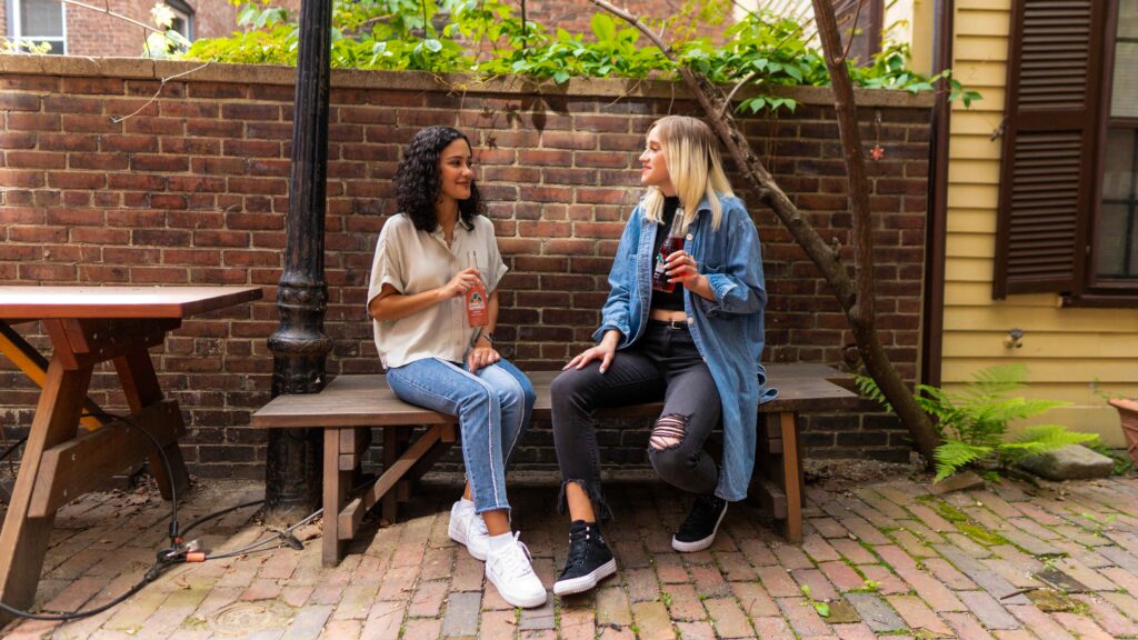 Two ladies chatting in a yard