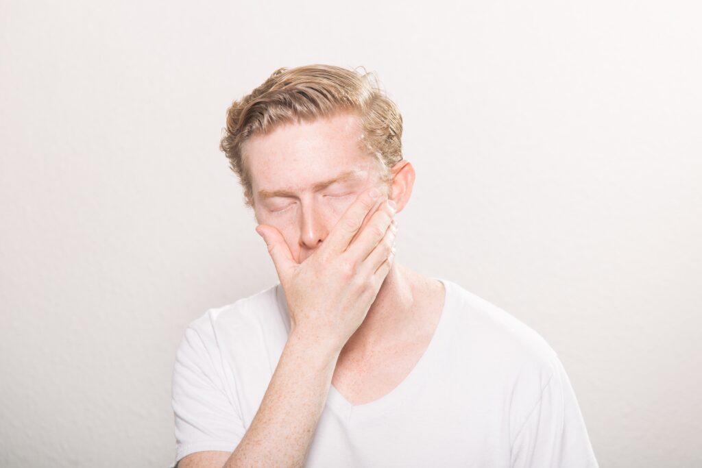 Man covering mouth with hand