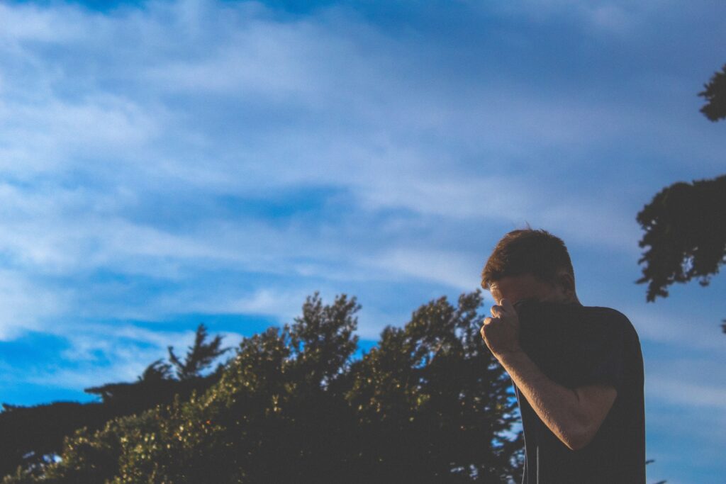 Boy covering his face