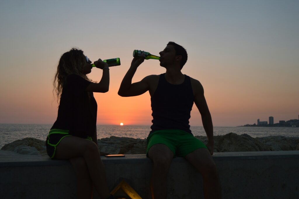 Boy and girl drinking from a bottle