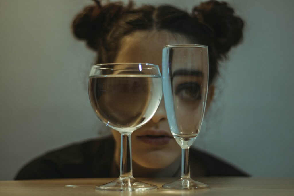 Girl looking through wine glass