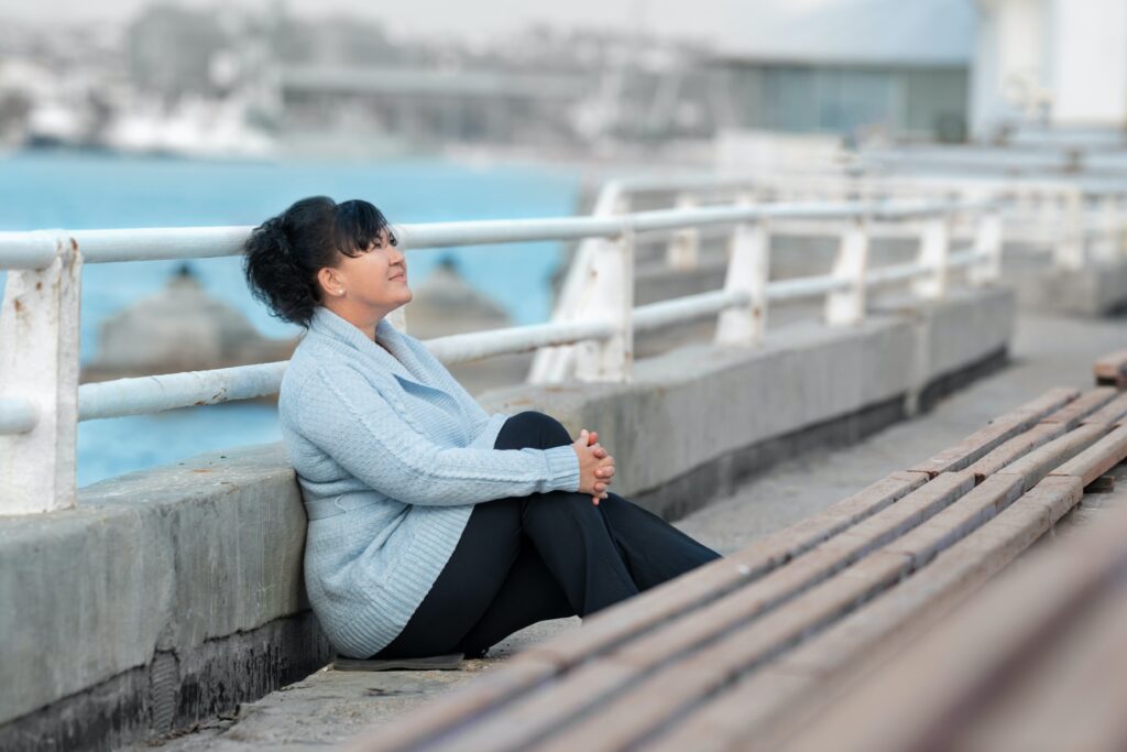 Lady sitting on a bridge