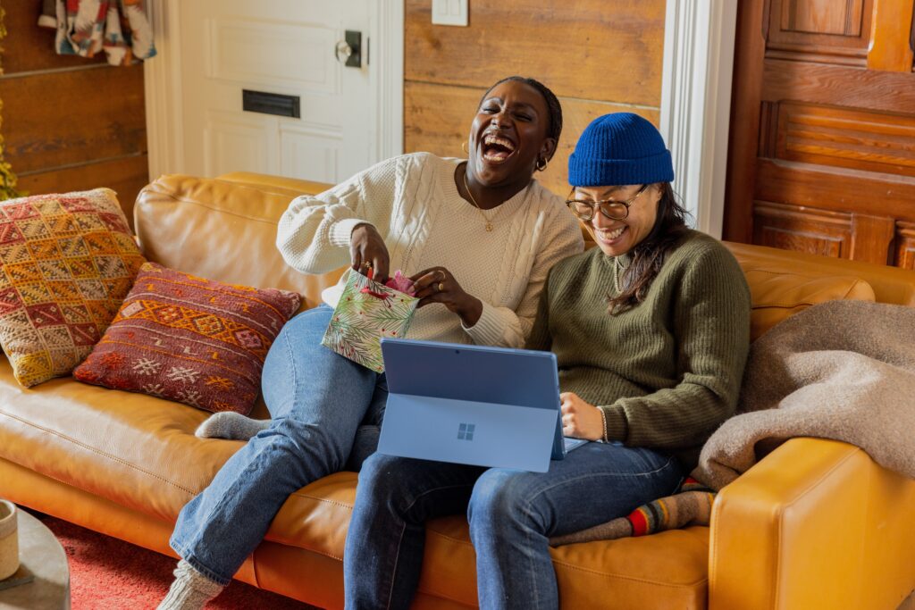 Two people Laughing while using the laptop