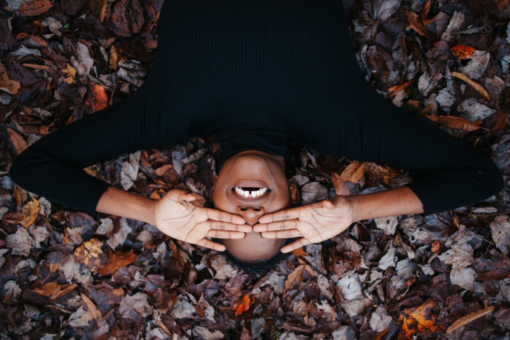 Girl lying on dry leaves