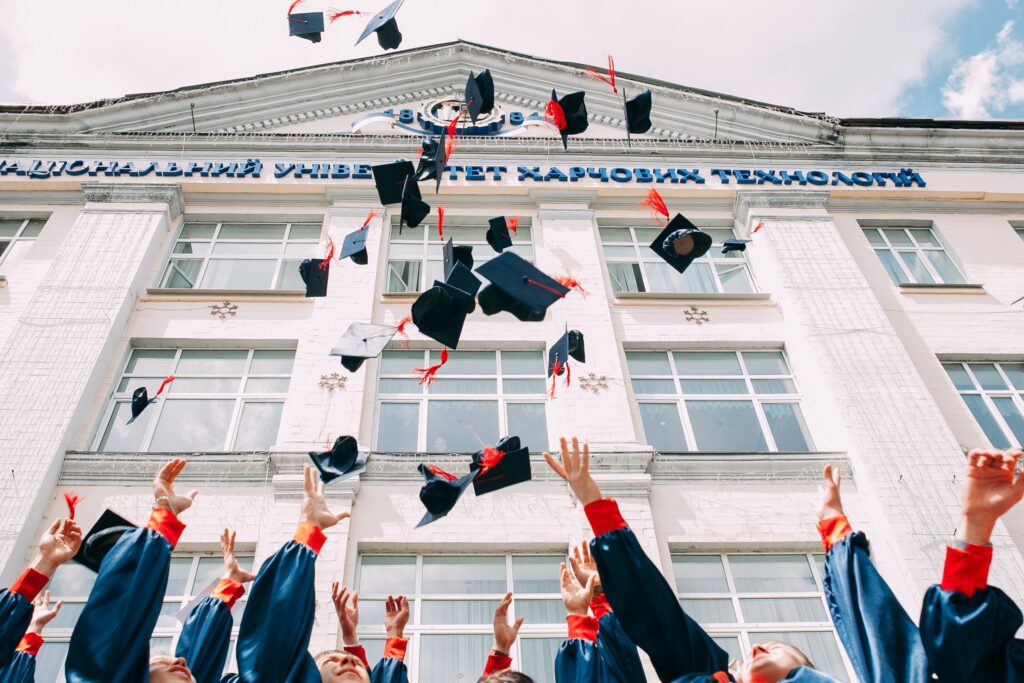 Graduation caps thrown in the air